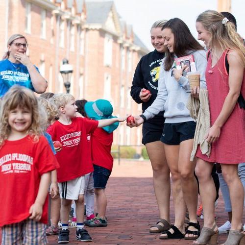 Randolph College Nursery School students hand out apples to their Randolph College 'classmates'.