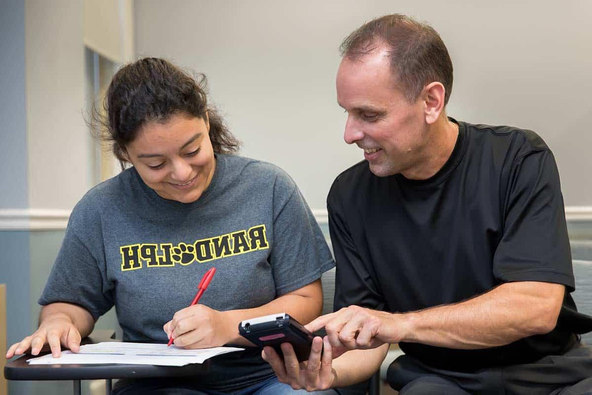 Professor Jeff Heinfeldt works with a student.