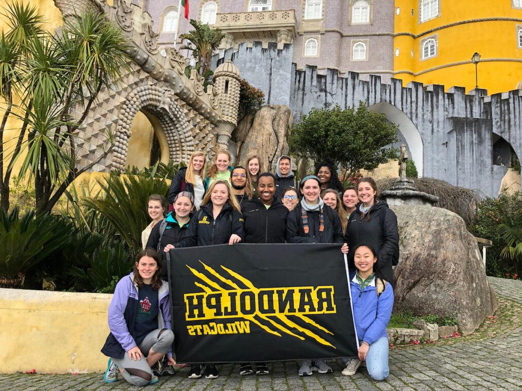 Students raise the Randolph College banner in Portugal.